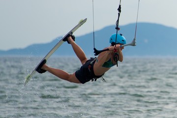 Close-up of female kite surfer getting air