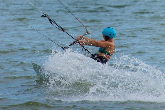 Close-up of female kite surfer causing spray