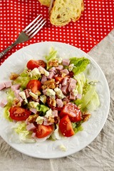 Fresh salad with ham, tomatoes and blue cheese