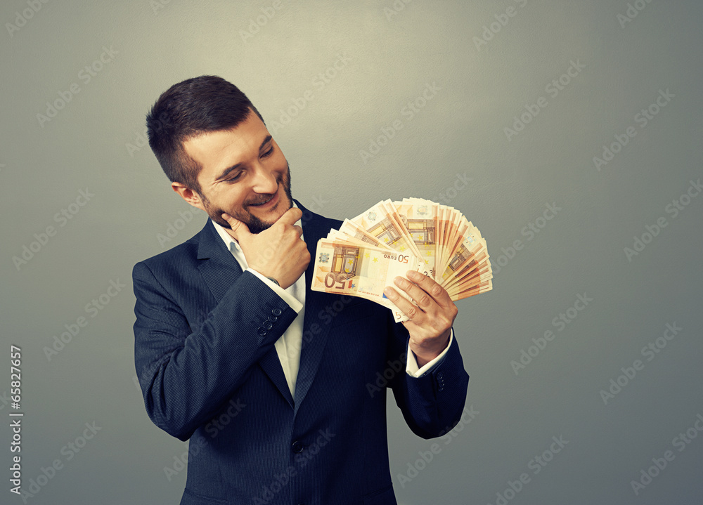 Poster man looking at money