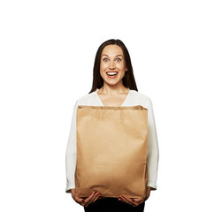 excited woman holding paper bag