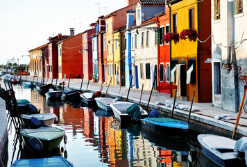 Fototapeta na wymiar Venice, Burano island, boats on canal and colorful houses, Italy