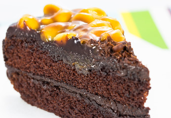 Chocolate cake slice isolated on white plate