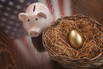 Golden Egg, Nest and Piggy Bank with American Flag Reflection