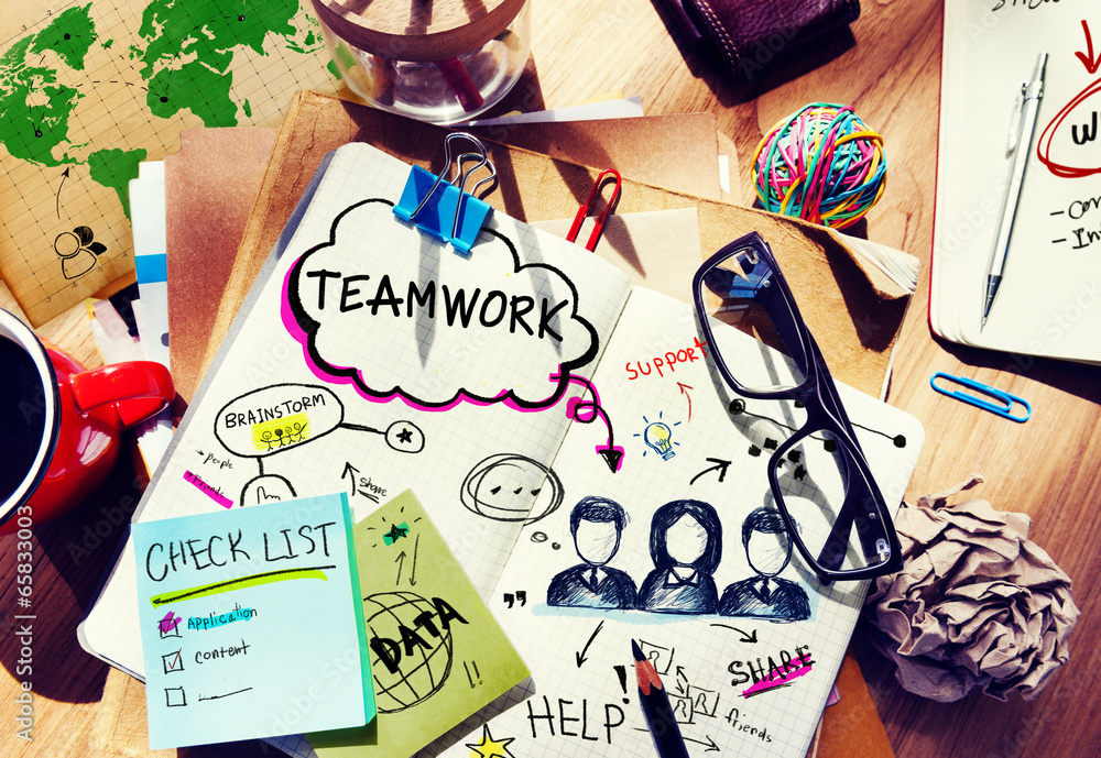 Aufkleber desk with tools and a notebook with ideas about teamwork