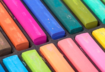 Detail of different colored chalk painting on white background