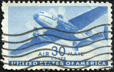 stamp shows image of a twin-engined transport plane