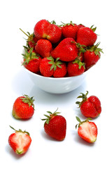 ripe strawberries in bowl, isolated on white background