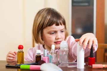  girl at  table with cosmetic products