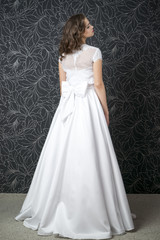 Fototapeta premium Beautiful woman in white wedding dress with corset