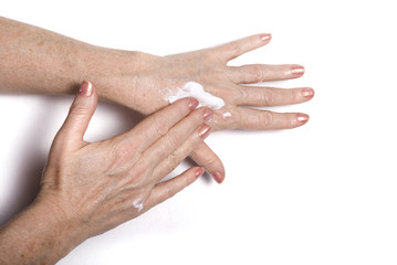 Fototapeta premium Mature woman applying cream