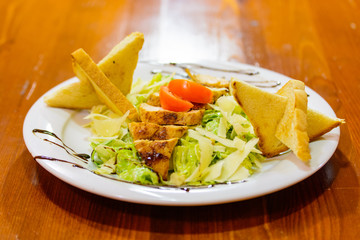 Caesar salad with chicken and toasts