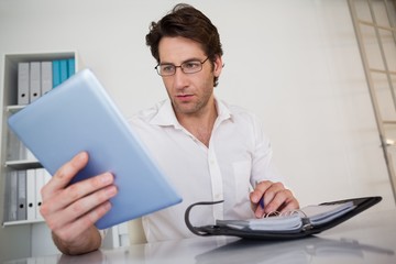 Casual businessman organizing his schedule at his desk