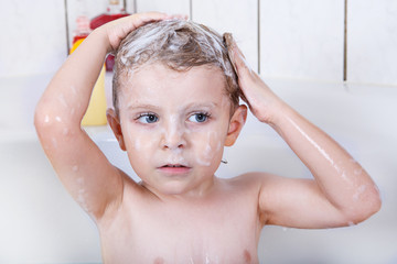 Cute little toddler boy of two years having fun by taking bath i © Irina Schmidt