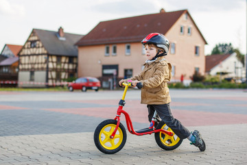Little toddler boy having fun and riding his bike