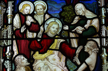 Christ healing sick and blind people. Stained glass.