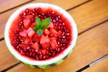 Fresh juicy watermelon decorated with heart pieces and pomegrana