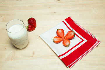 composition of strawberry fruits with milk on wooden table