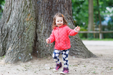 Cute little girl having fun with soap bubbles © Irina Schmidt