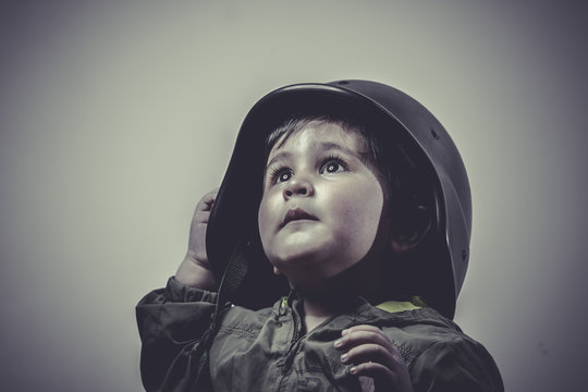 fighter, fun and funny child dressed in military cap, playing wa