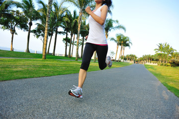 woman runner athlete running at tropical park