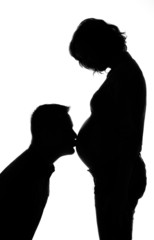 Silhouette of couple awaiting baby