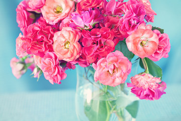 bright bouquet of a beautiful tea roses in a vase