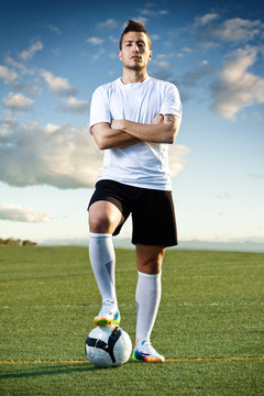 Fototapeta Soccer player with ball, outdoors