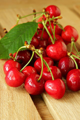 Ripe cherries on a wooden table.