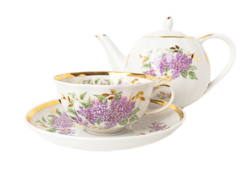 Porcelain teapot, teacup and saucer on white