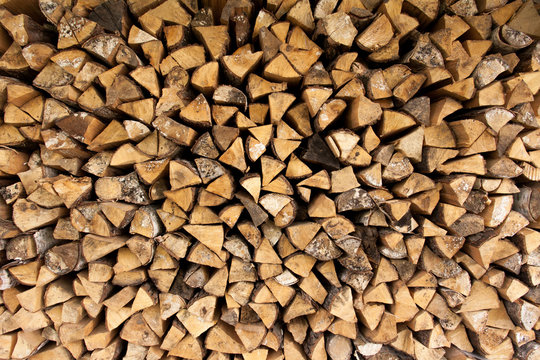 Background of chopped firewood logs in a pile