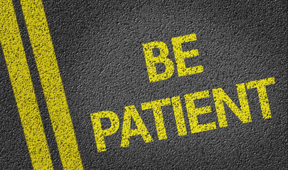 Be Patient written on the road