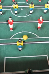 Fototapeta premium Foosball football soccer tabletop in team colors red white yellow and blue