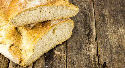 Cutting bread on wooden table
