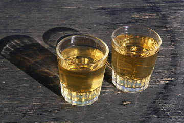 two glass of white vine on oak barrel