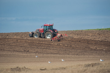 Obraz premium Tractor ploughing agricultural land