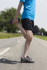 Jogger man stretching his legs