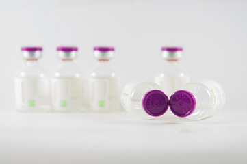 Purple cap injection vials show medicine concept