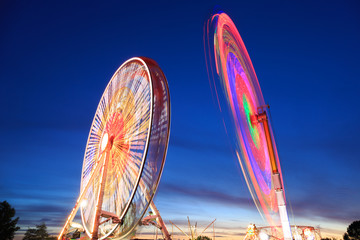 Amusement park at dusk - Ferris wheel in motion