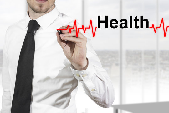 doctor in hospital drawing heartbeat line with healt in the air