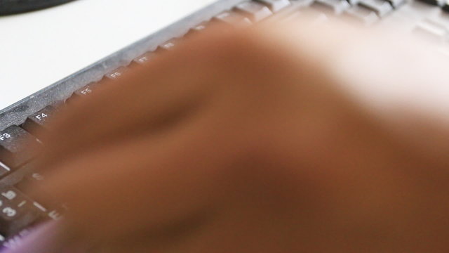 man to clening dust on key board by brush