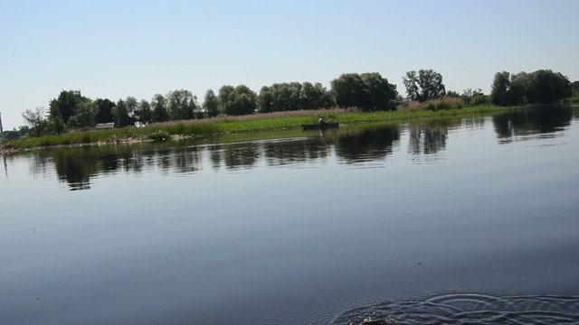 Birzai town lake view from boat forests shrubs fisherman boat