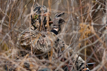 a hunter with a wooden duck call