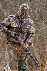 the hunter in camouflage with a gun