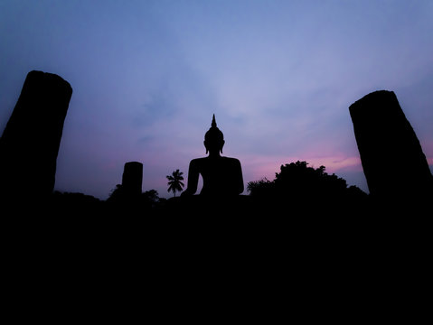 Silhouette buddha image at twilight at Wat Mahathat Sukhothai Th