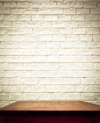 white brick wall and wooden table