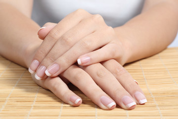 Obraz na płótnie Canvas Beautiful woman hands and nails with perfect french manicure