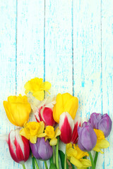 Beautiful flowers on color wooden background