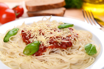 Pasta with tomato sauce on plate on table close-up