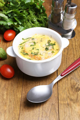 Tasty soup in saucepan on wooden table, close up